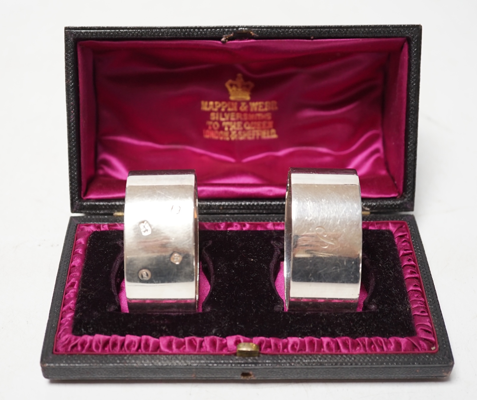 A pair of silver oval napkin rings, engraved 'B' and 'J', London 1990, maker Francis Howard, Condition - fair